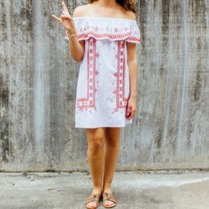 Off-the-shoulder white dress, burnt orange accents